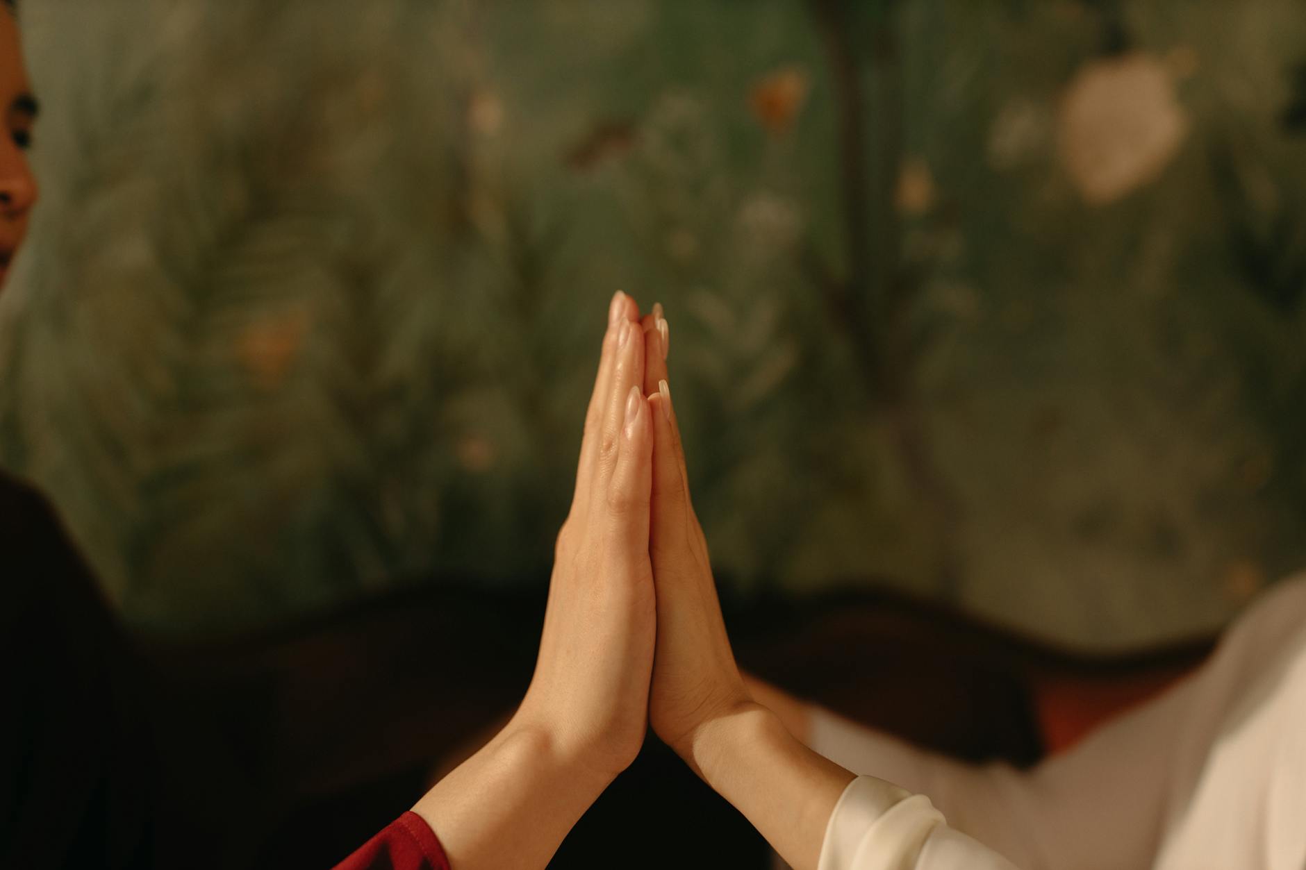 close up of two people touching with their palms